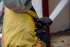 Firefighter spraying hose